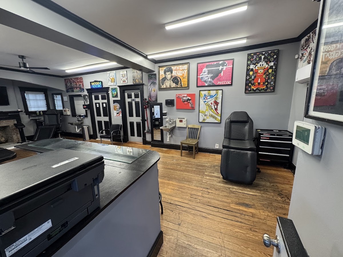 Tattoo studio interior at Long Island Ink with framed art and a tattoo chair